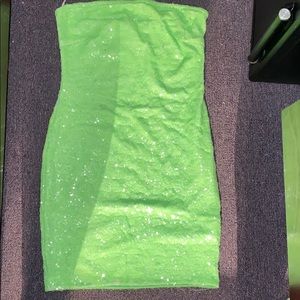 A cute off the shoulder , green , sparkly sequin